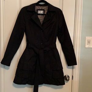 Black Trench Coat with Ruffle Details at Bottom
